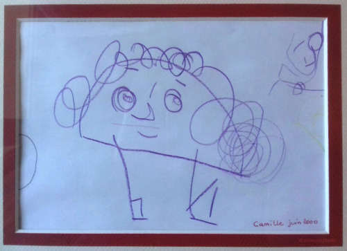 A photo of a child's drawing of a potato person. The potato person
has hair, eyebrows, two eyes, a nose and mouth, as well s two legs, but no arms.
Down at the bottom right corner, someone wrote Camille, june 2000.